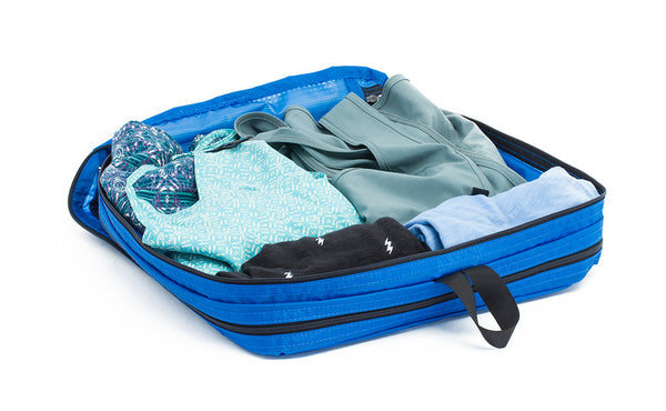 An open Island (blue) Aether Large Laundry Aeronaut 30 Packing Cube holding a change of clothes.